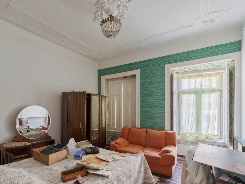 Altbau-Schlafzimmer mit Möbeln und Kronleuchter vor der Wohnungsauflösung